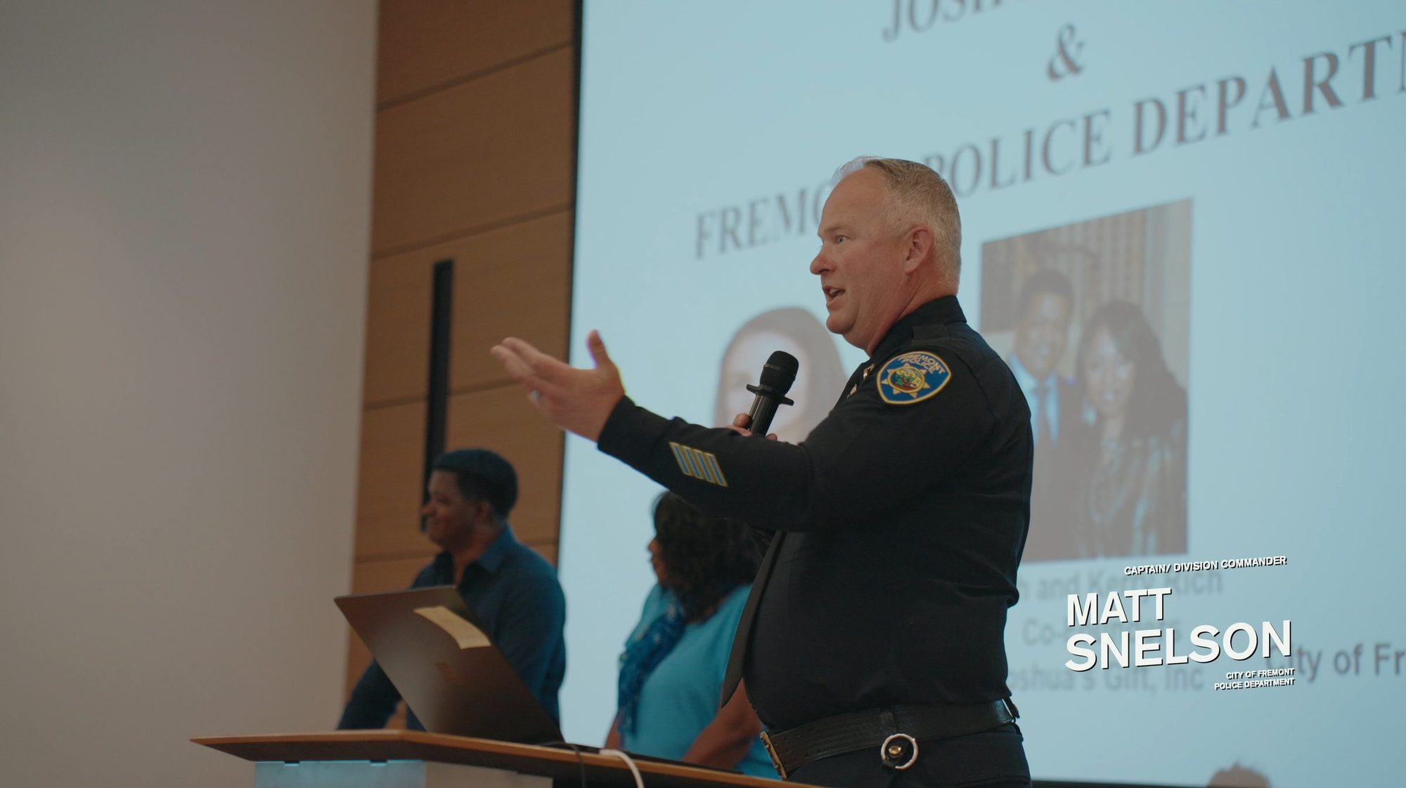 Police officer speaking at the community meeting